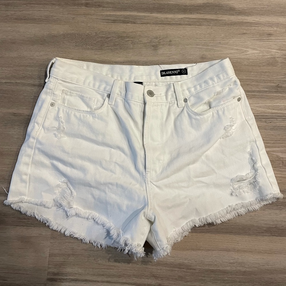 White ripped shorts
